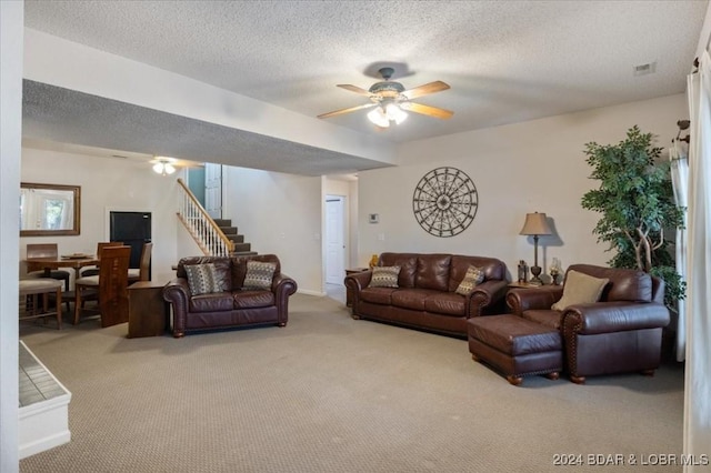 living room with light carpet, a textured ceiling, and ceiling fan