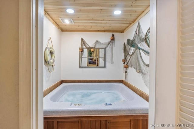 bathroom featuring a bath and wooden ceiling