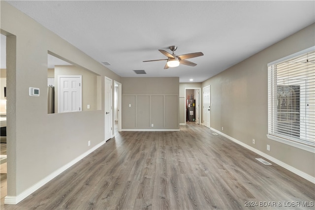 spare room with ceiling fan and light wood-type flooring