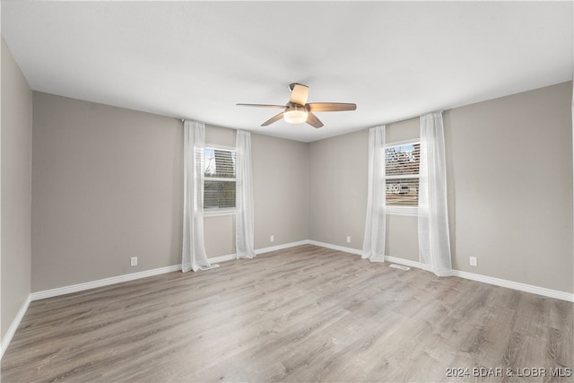 empty room featuring ceiling fan and light hardwood / wood-style floors