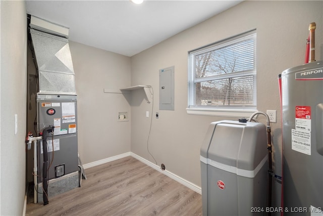 washroom featuring washer hookup, electric water heater, electric panel, and light hardwood / wood-style flooring