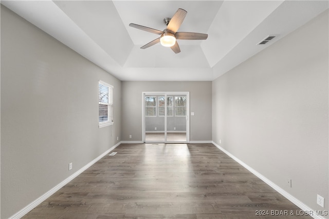 spare room with dark hardwood / wood-style flooring, vaulted ceiling, and ceiling fan