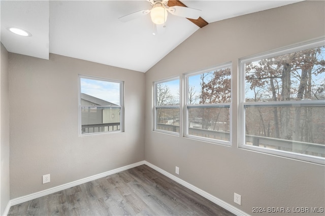 unfurnished room with ceiling fan, wood-type flooring, and vaulted ceiling