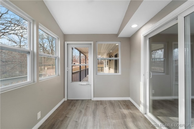 unfurnished sunroom with lofted ceiling