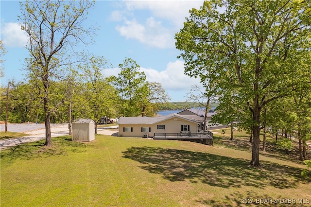 view of yard with a storage shed and a wooden deck