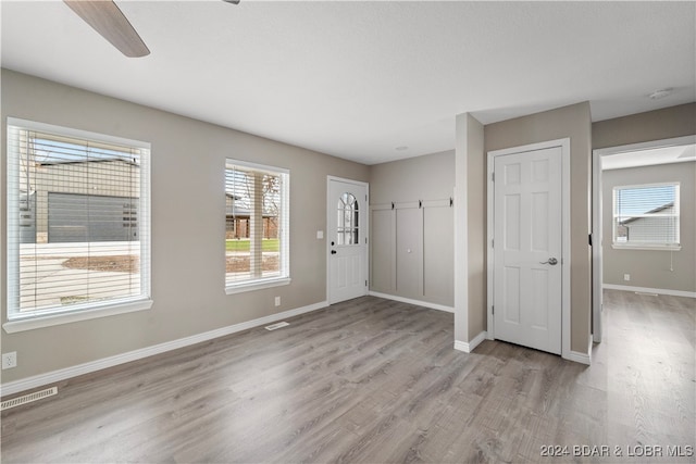 entryway with light wood-type flooring and ceiling fan