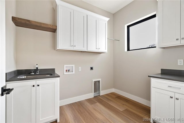 laundry room featuring sink, washer hookup, cabinets, electric dryer hookup, and light hardwood / wood-style flooring