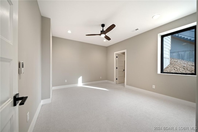 empty room featuring light colored carpet and ceiling fan