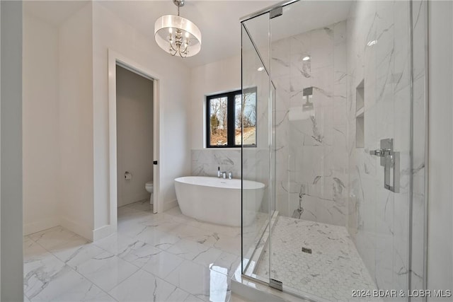 bathroom featuring plus walk in shower, a chandelier, and toilet