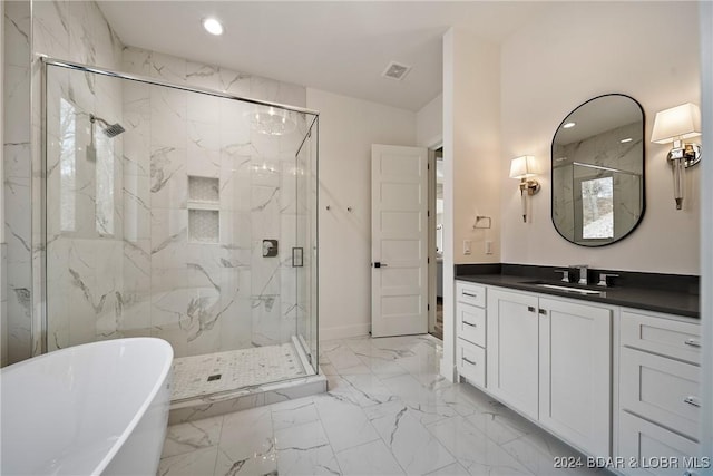 bathroom featuring vanity and separate shower and tub