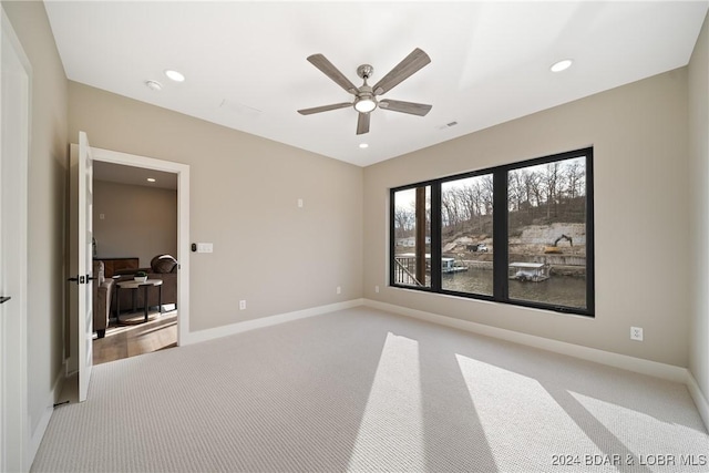 unfurnished bedroom featuring ceiling fan and light carpet