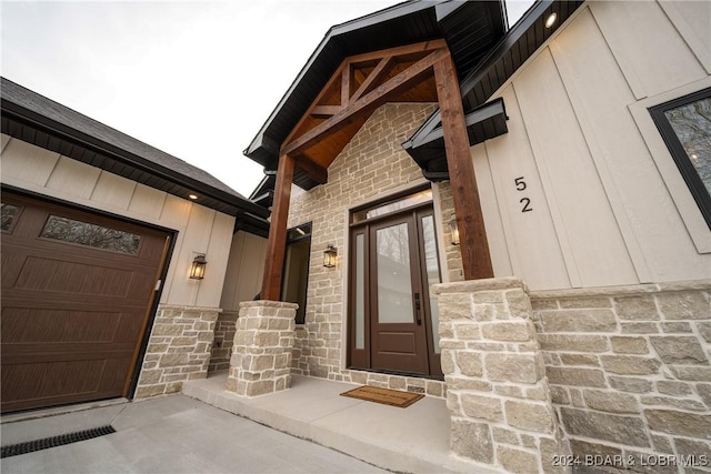 doorway to property with a garage