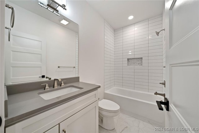 full bathroom with vanity, tiled shower / bath combo, and toilet