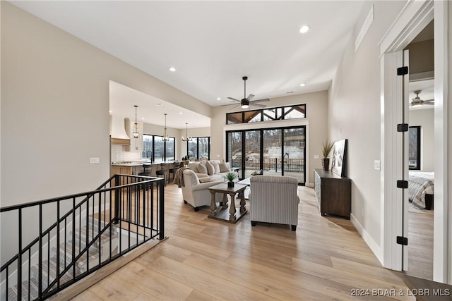 living room featuring plenty of natural light, light hardwood / wood-style floors, and ceiling fan