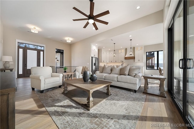 living room with hardwood / wood-style floors, plenty of natural light, and ceiling fan