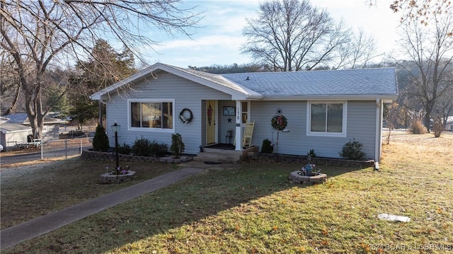 single story home featuring a front lawn