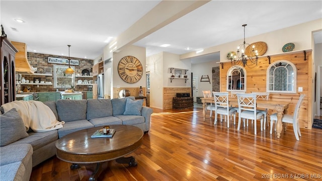 living room featuring a notable chandelier and wood-type flooring