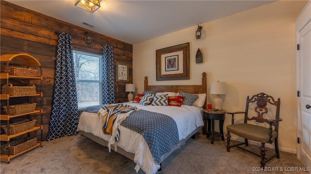 bedroom featuring carpet and wood walls