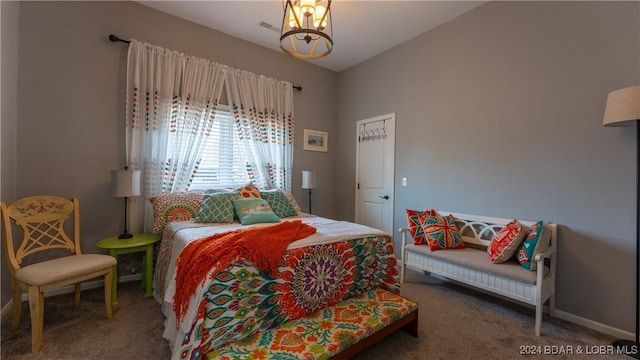 carpeted bedroom featuring a notable chandelier