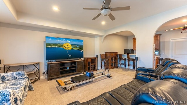 carpeted living room featuring ceiling fan