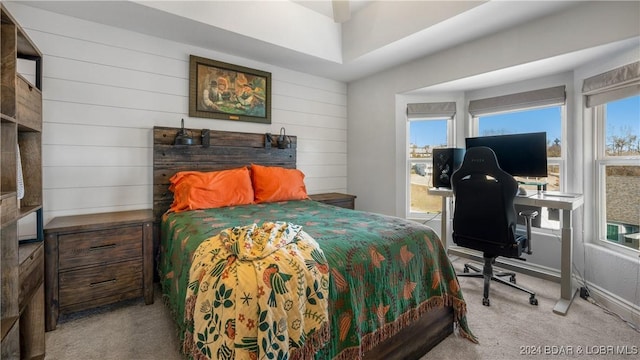 carpeted bedroom featuring multiple windows