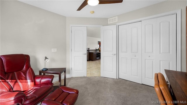 sitting room featuring ceiling fan and light colored carpet