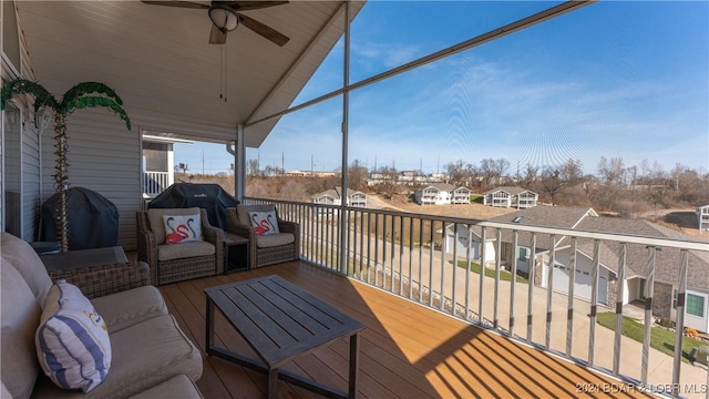 wooden terrace featuring ceiling fan and a grill