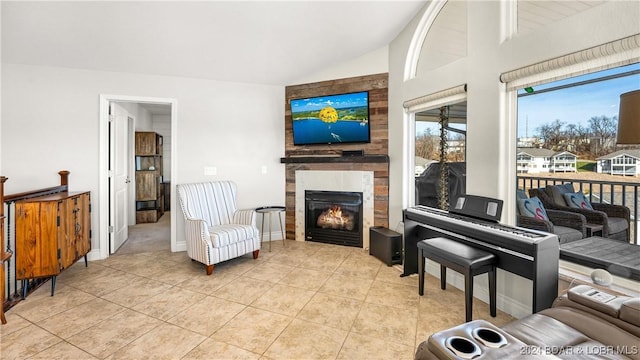 living room featuring light tile patterned floors, a tile fireplace, and vaulted ceiling