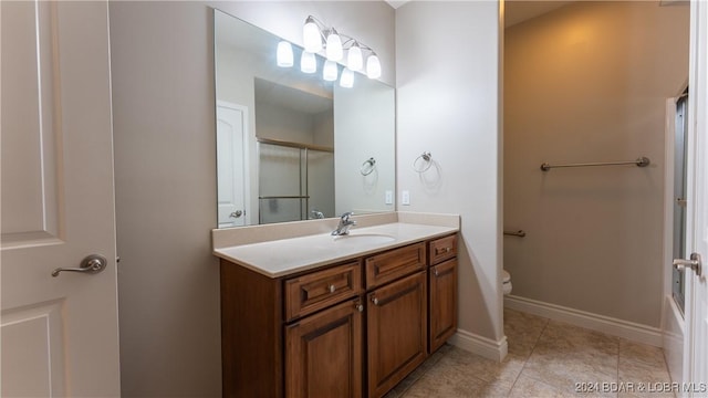 bathroom with tile patterned floors, vanity, and toilet