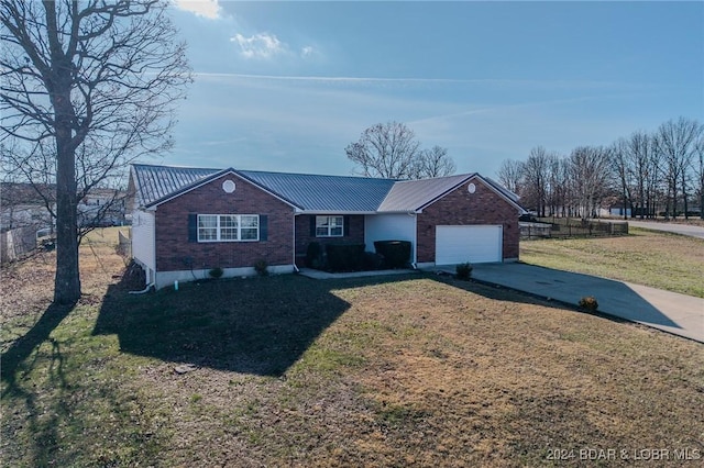 single story home featuring a garage and a front yard