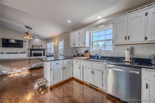 kitchen with stainless steel dishwasher, dark hardwood / wood-style flooring, white cabinets, and sink