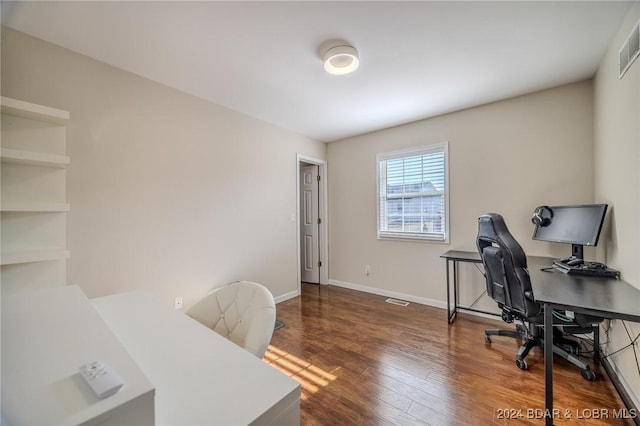 home office with dark hardwood / wood-style floors