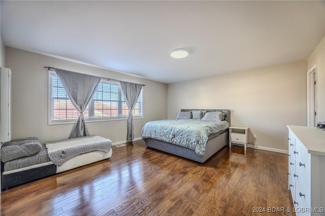 bedroom with dark wood-type flooring