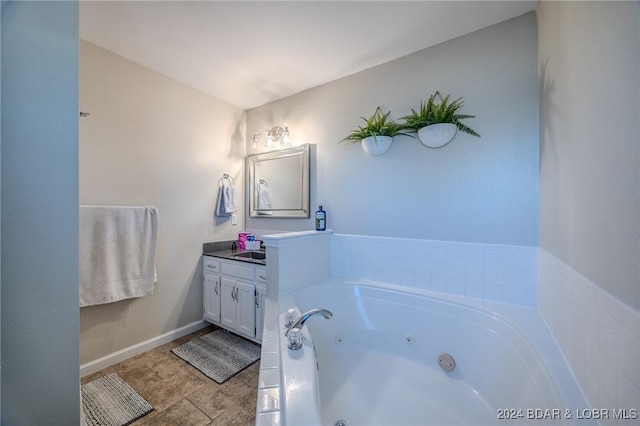 bathroom featuring tile patterned flooring, vanity, and a bath