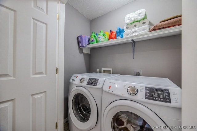 clothes washing area with a textured ceiling and washing machine and clothes dryer