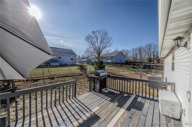 deck featuring central AC and a grill