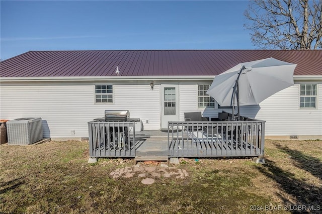 back of house featuring a yard, a deck, and cooling unit