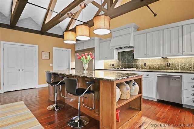 kitchen featuring pendant lighting, white cabinetry, a center island, and stainless steel appliances