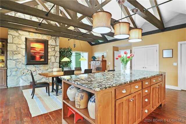 kitchen featuring stone counters, beam ceiling, dark hardwood / wood-style floors, and high vaulted ceiling