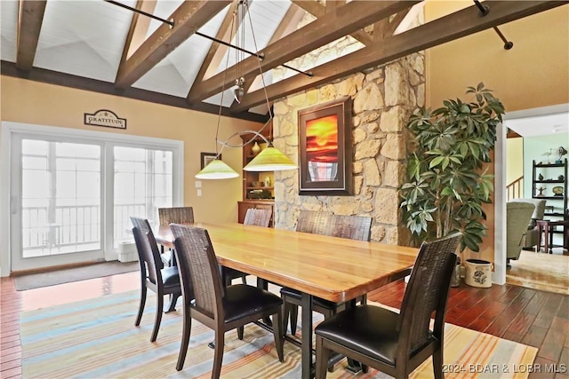 dining room with beam ceiling, high vaulted ceiling, and hardwood / wood-style flooring