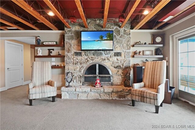 sitting room featuring carpet, a fireplace, and beamed ceiling