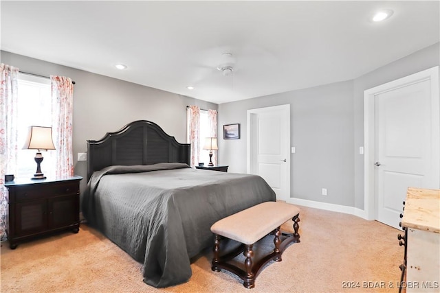 bedroom with ceiling fan and light carpet