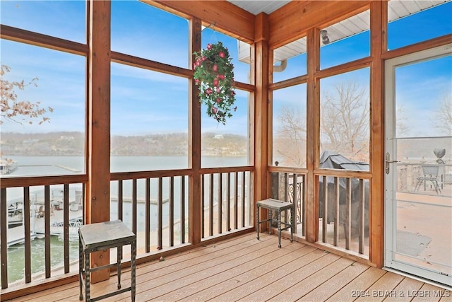 sunroom / solarium with a water view