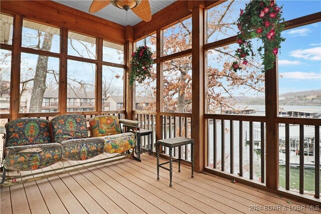 unfurnished sunroom featuring ceiling fan