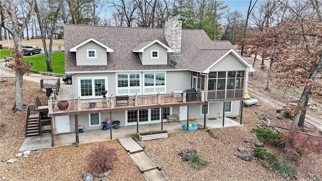 back of property with a patio area, a sunroom, and a wooden deck