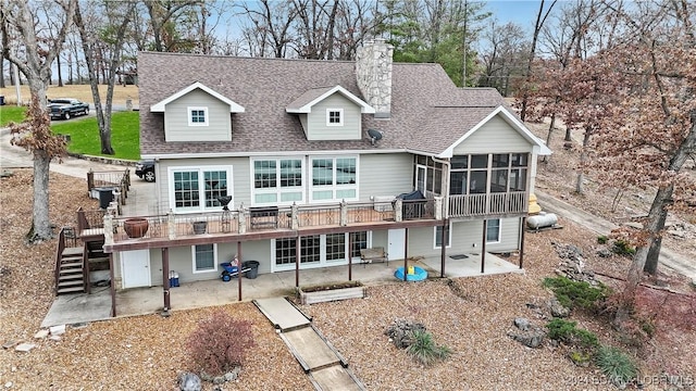 back of house featuring a patio, a sunroom, and a deck