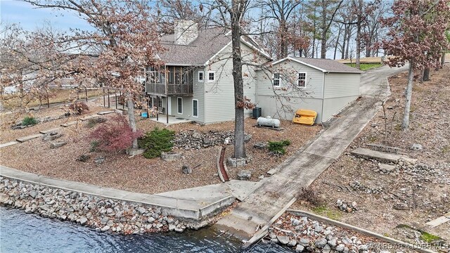 view of side of property with a water view and cooling unit