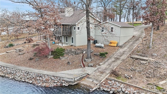 exterior space with a patio, a water view, and central air condition unit