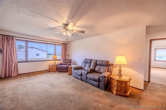 living room with carpet floors, a healthy amount of sunlight, and a textured ceiling