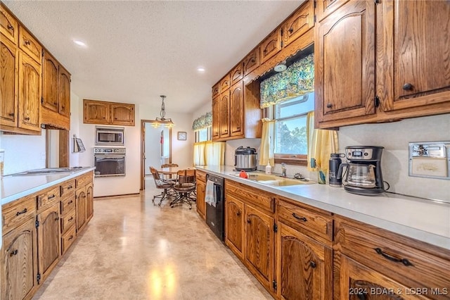 kitchen with a textured ceiling, sink, decorative light fixtures, and black appliances